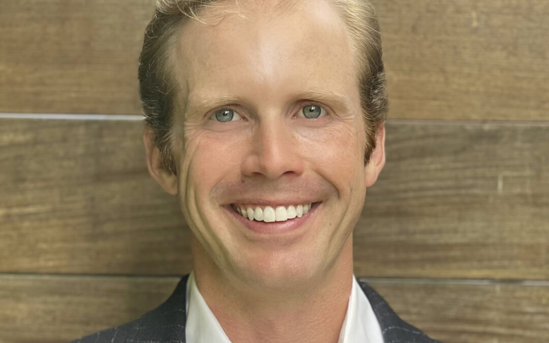 Smiling man close-up with wooden background